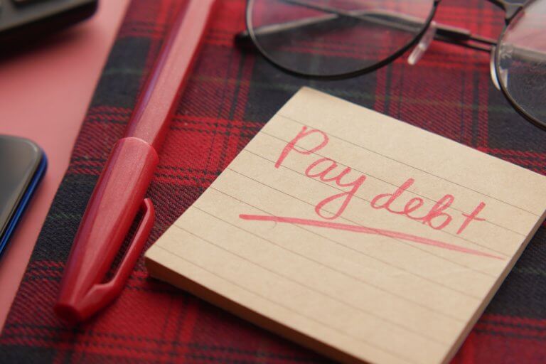 How long does it take for a credit score to go up after paying off debt?