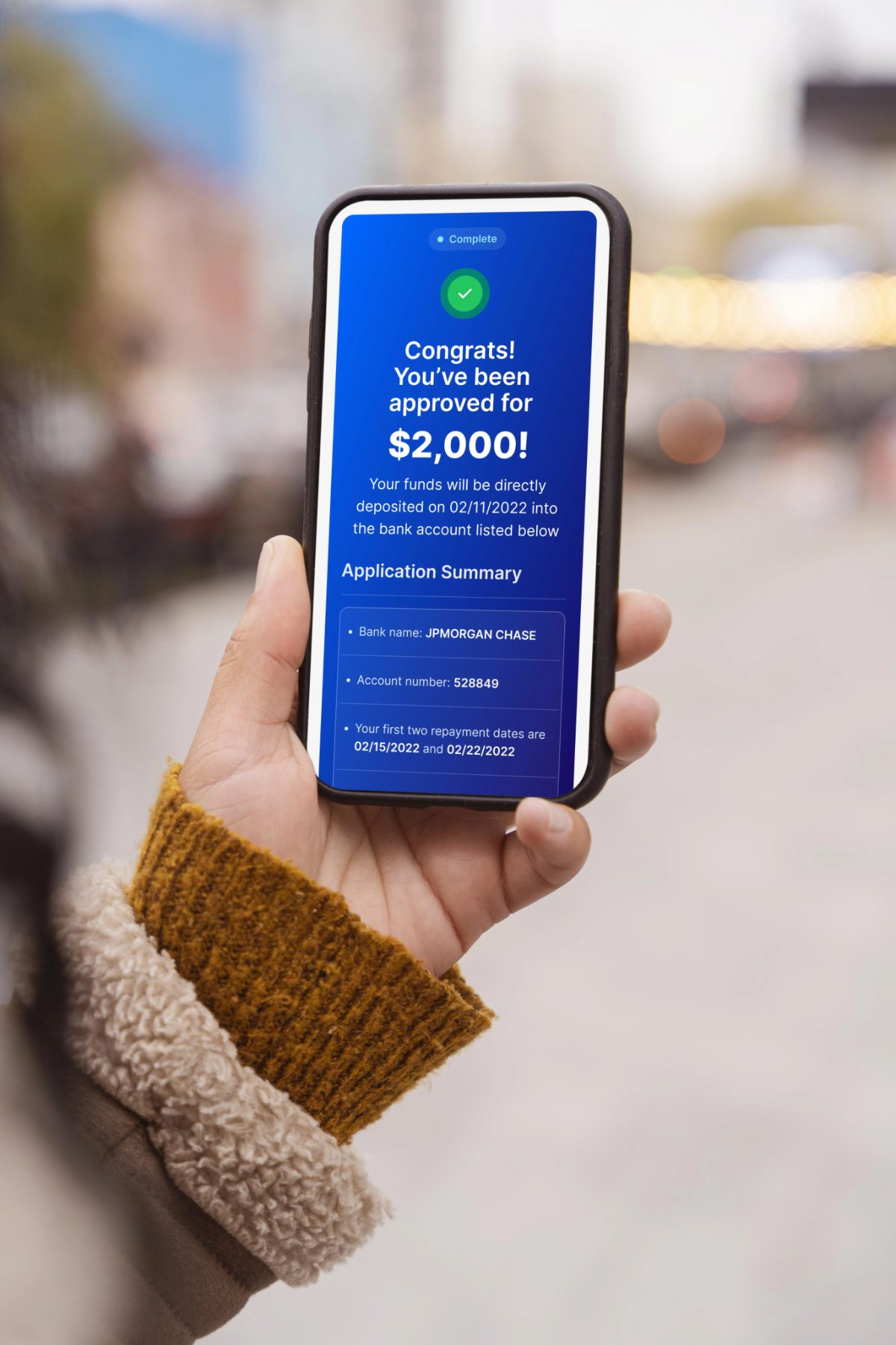 Person happily checking their loan application on a phone