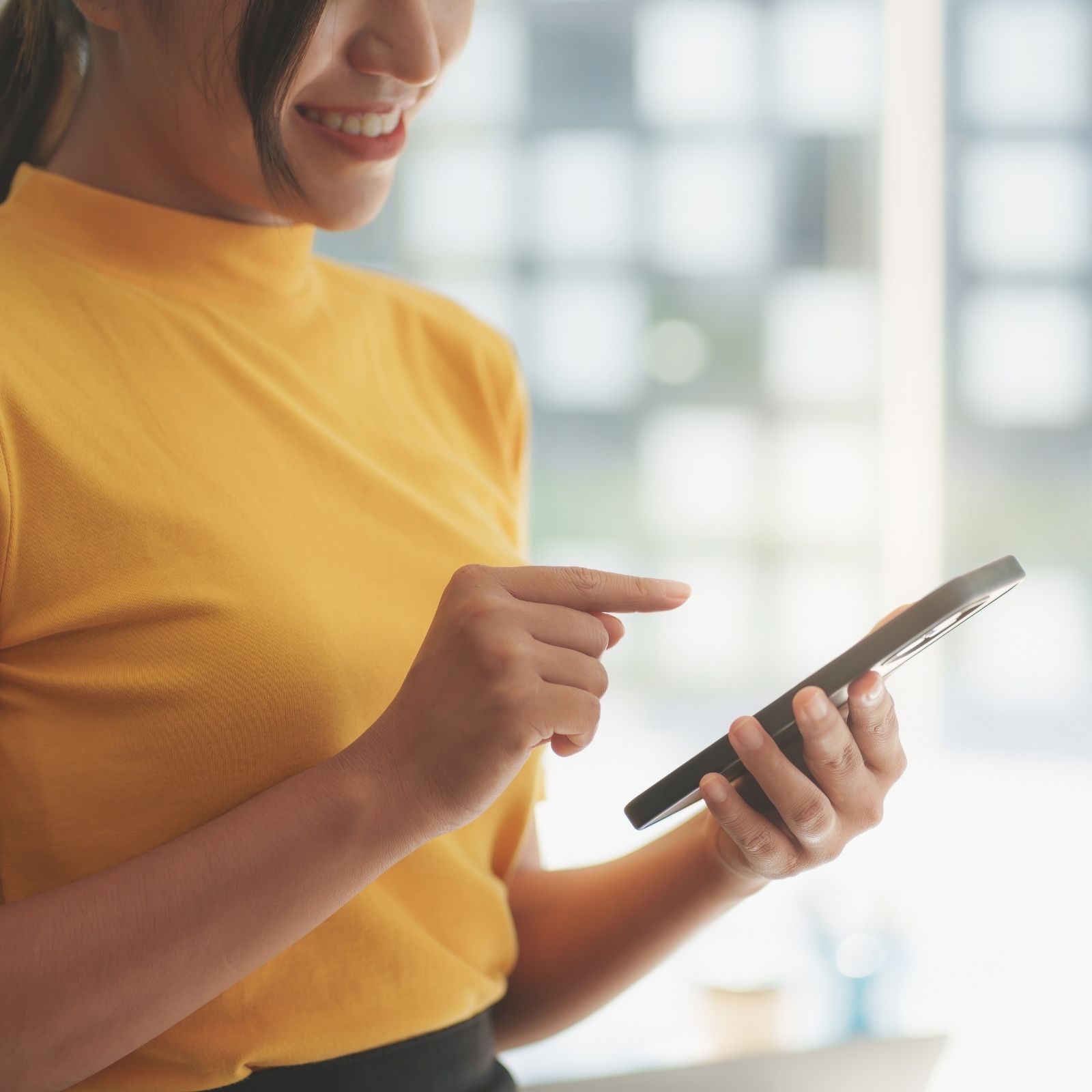 CreditNinja customer smiling while using the app on a phone